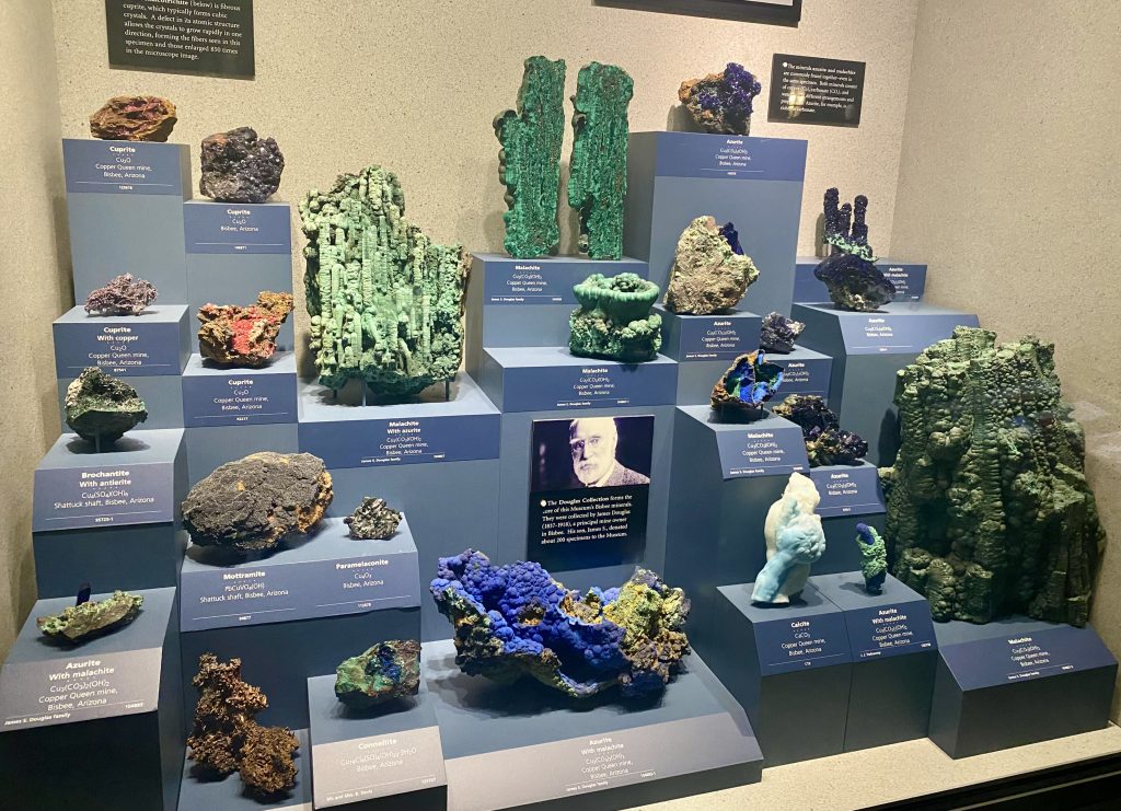 A display case with many different types of colorful rocks.