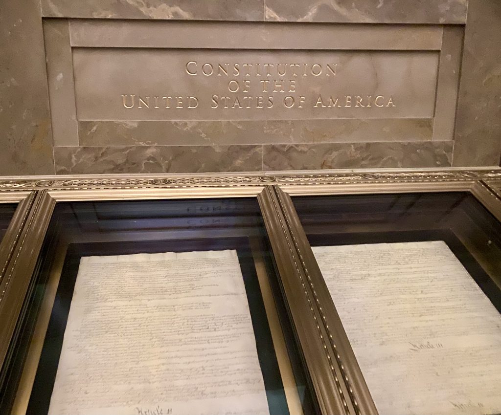 Constitution of the United States in glass display case at National Archives in Washington DC