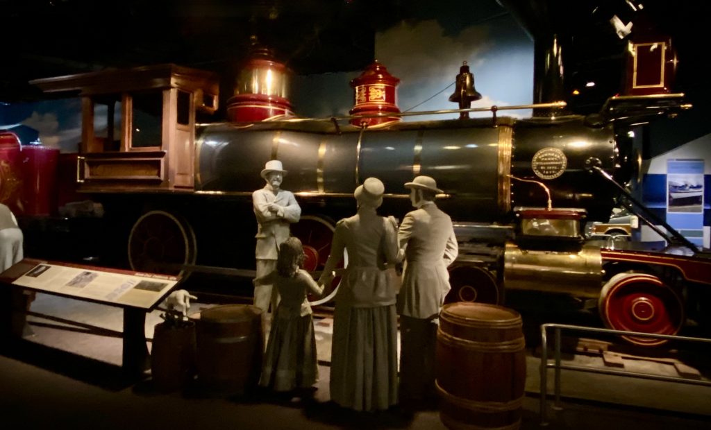 Full size steam train engine with mannequins (3 adults and 1 child) at National Museum of American History in Washington DC