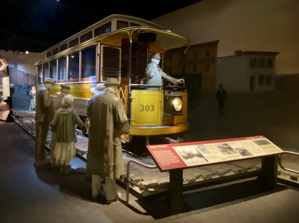 Life size yellow street car with conductor mannequin on front at National Museum of American History in Washington DC