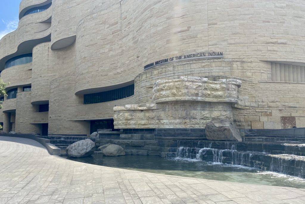 Outside entrance of the National Museum of the American Indian in Washington DC with fountain flowing out of building
