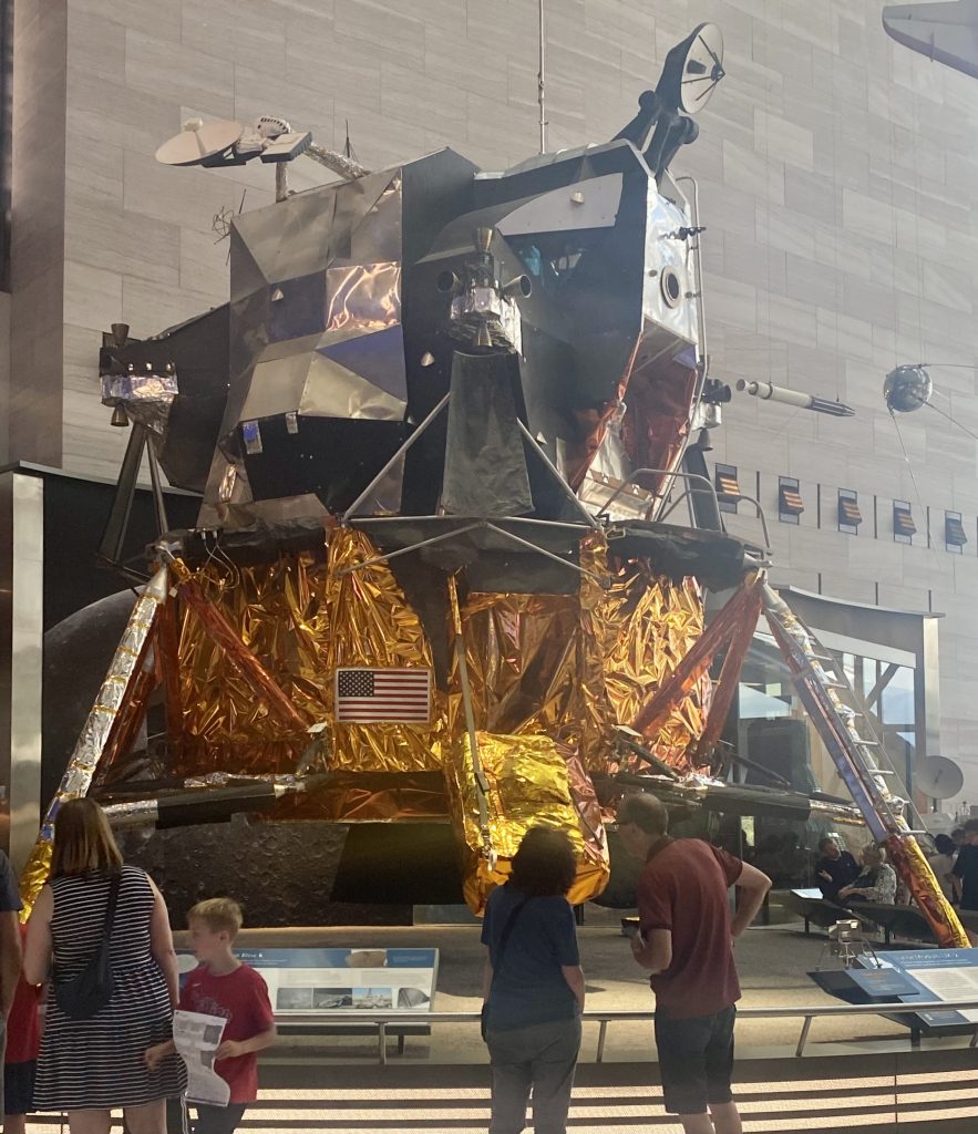People looking at a lunar module on display at the National Air and Space Museum in Washington DC