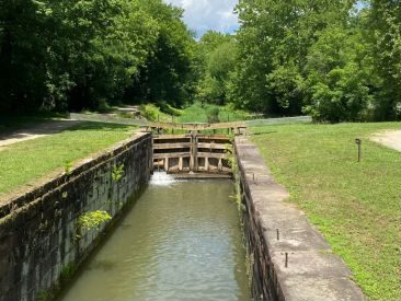 narrow canal leading to wooden lock gate