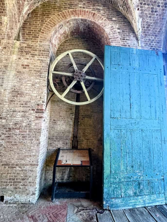 Large gear behind green door that opens fort gates
