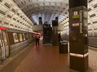 Eastern Market Metro Station with train on one side and people waiting