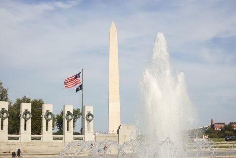 Fountain and American flag with Washington Monument in the background